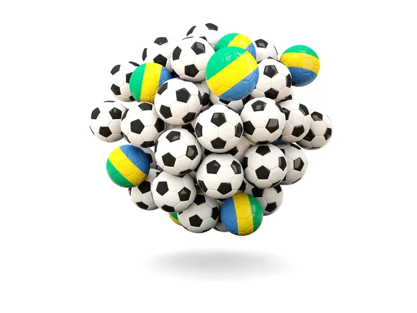 Montón de balones de fútbol con bandera de gabón — Foto de Stock