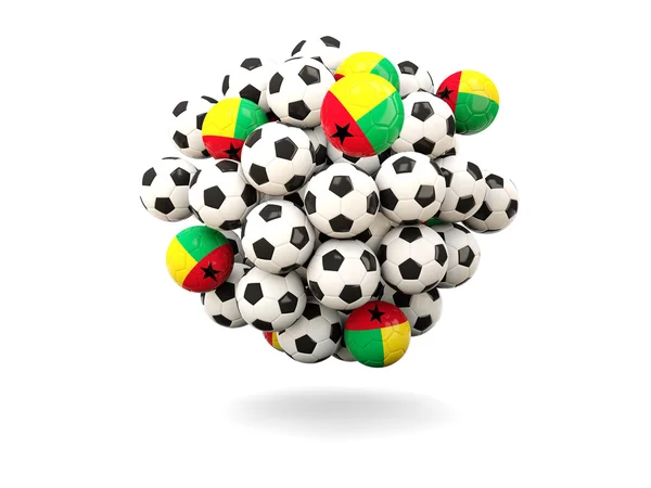 Montón de balones de fútbol con bandera de Guinea Bissau — Foto de Stock