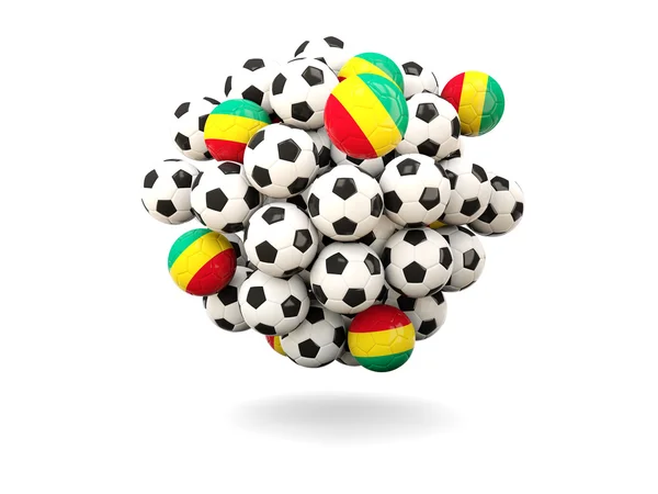 Montón de balones de fútbol con bandera de Guinea — Foto de Stock
