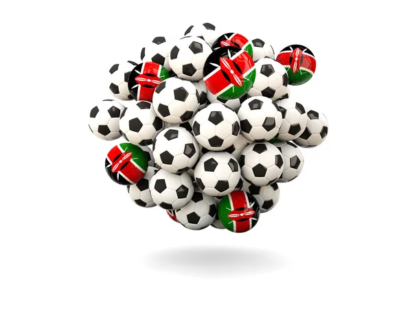 Mucchio di palloni da calcio con bandiera di kenya — Foto Stock