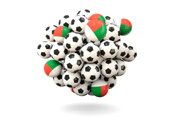 Hög med fotbollar med flagga Madagaskar — Stockfoto