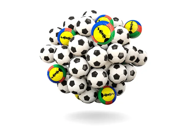 Montón de balones de fútbol con bandera de nueva caledonia — Foto de Stock