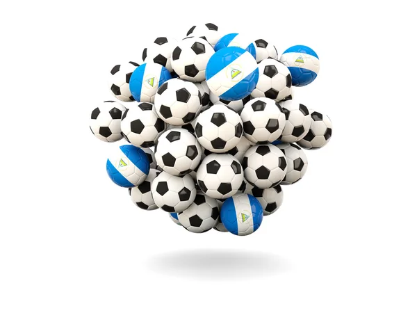 Pilha de bolas de futebol com bandeira de nicarágua — Fotografia de Stock