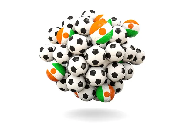 Mucchio di palloni da calcio con bandiera di niger — Foto Stock