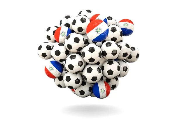 Куча футбольных мячей с флагом Парагвая — стоковое фото