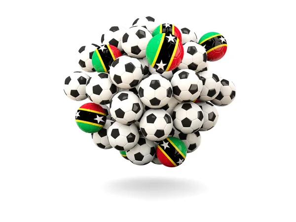 Pile de ballons de football avec drapeau de saint kitts et nevis — Photo