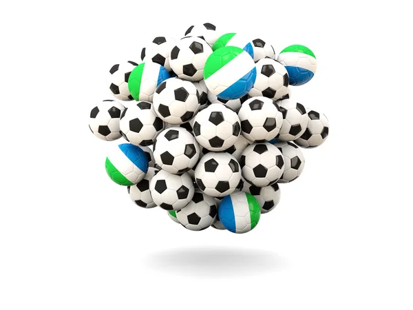 Montón de balones de fútbol con bandera de Sierra Leona — Foto de Stock
