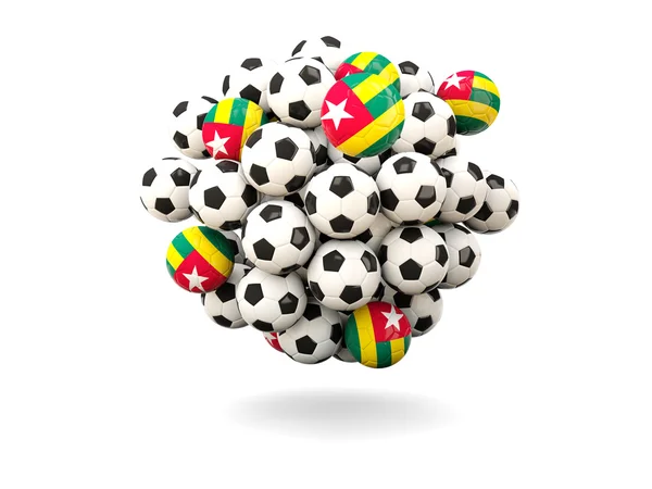 Pilha de bolas de futebol com bandeira de togo — Fotografia de Stock