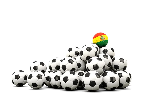 Mucchio di palloni da calcio con bandiera della Bolivia — Foto Stock