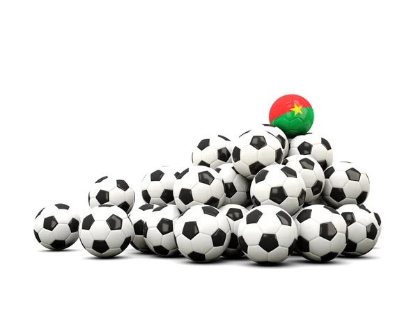 Mucchio di palloni da calcio con bandiera di burkina faso — Foto Stock