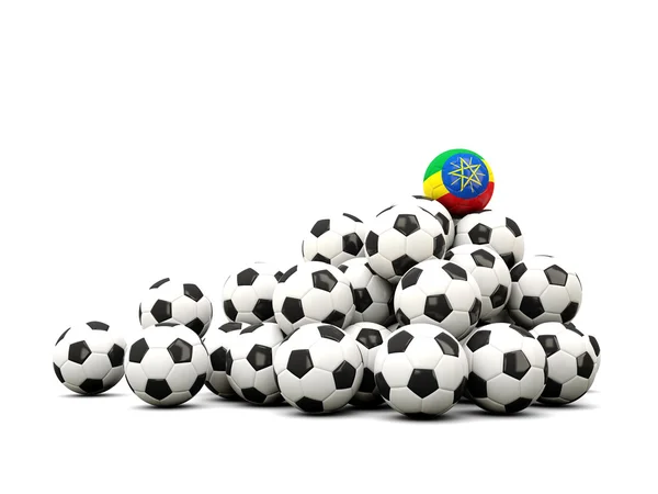 Högen av bollar fotboll med flagga av Etiopien — Stockfoto