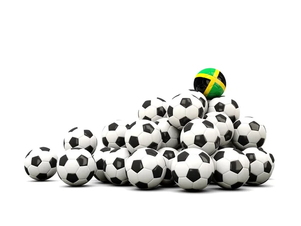 Pilha de bolas de futebol com bandeira de jamaica — Fotografia de Stock