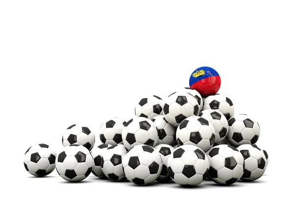 Högen av bollar fotboll med flagga liechtenstein — Stockfoto
