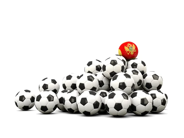 Mucchio di palloni da calcio con bandiera di montenegro — Foto Stock