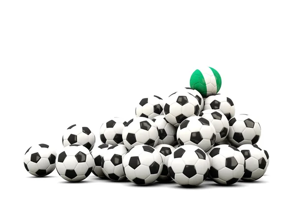 Högen av bollar fotboll med flagga i nigeria — Stockfoto