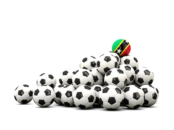 Pilha de bolas de futebol com bandeira de saint kitts e nevis — Fotografia de Stock
