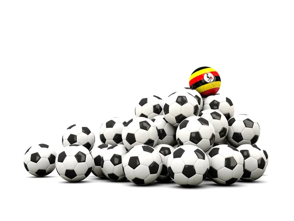 Högen av bollar fotboll med flagga i uganda — Stockfoto