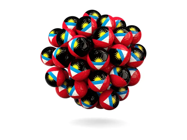 Pile de ballons de football avec drapeau d'Antigua et Barbuda — Photo