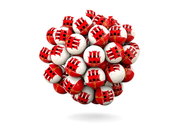 Pile de ballons de football avec drapeau de gibraltar — Photo