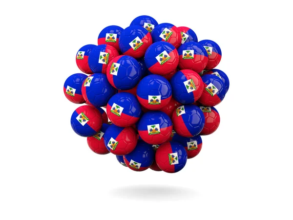 Pile de ballons de football avec drapeau de haiti — Photo