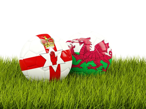 Northernn Ireland and Wales soccer balls on grass — Stock Photo, Image