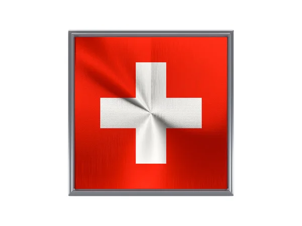 Square metal button with flag of switzerland — стокове фото