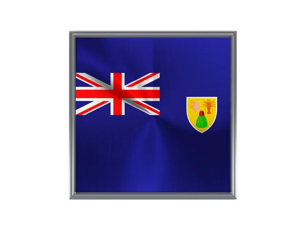 Квадратна металева кнопка з прапором островів Турків і Кайкос — стокове фото