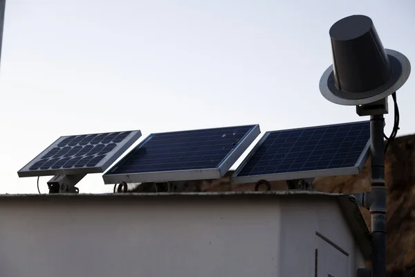 Three Solar Panels Powering Outdoor Lighting Building — Stock Photo, Image