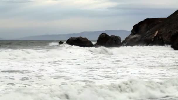 Μέτρια Wide πυροβόλησε των κυμάτων χτύπημα Ακρωτήρι βράχια — Αρχείο Βίντεο