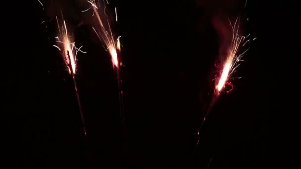 Closeup Three Sparklers Burning Against Black Background — Stock Video