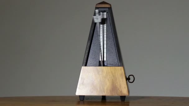 Metronome On Table Gray Background Largo Tempo — Stock Video