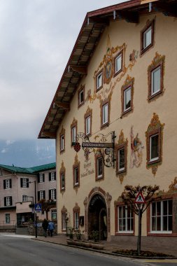 Golling, Austria -  April 12, 2019: Main street of the town, with traditional illustrative painting on the facades.