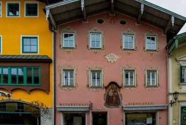 Golling, Austria -  April 12, 2019: Main street of the town, with traditional illustrative painting on the facades.