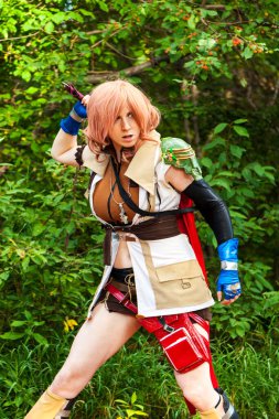 Calgary, Canada - September 01, 2014: Cosplayer dressed up as Viking warrior girl with sword fight.