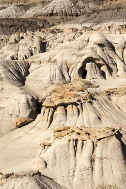 Drumheller badlands at the Dinosaur Provincial Park in Alberta, where rich deposits of fossils and dinosaur bones have been found. The park is now an UNESCO World Heritage Site. clipart