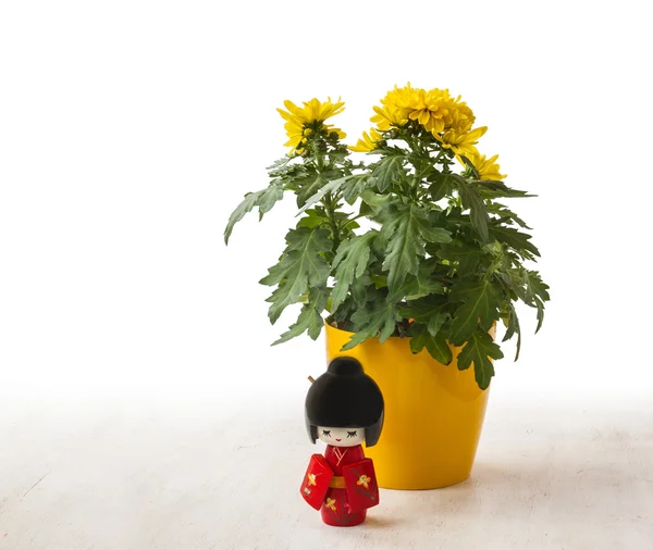 Poupée Kokeshi et chrysanthèmes jaunes — Photo