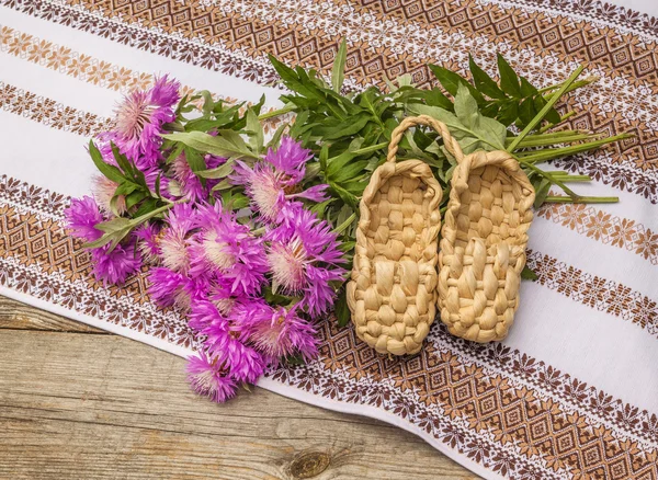 Cornflowers and bast shoes — Stock Photo, Image