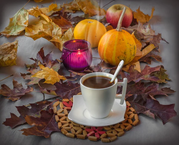 Cup of coffee with fallen leaves — Stock Photo, Image