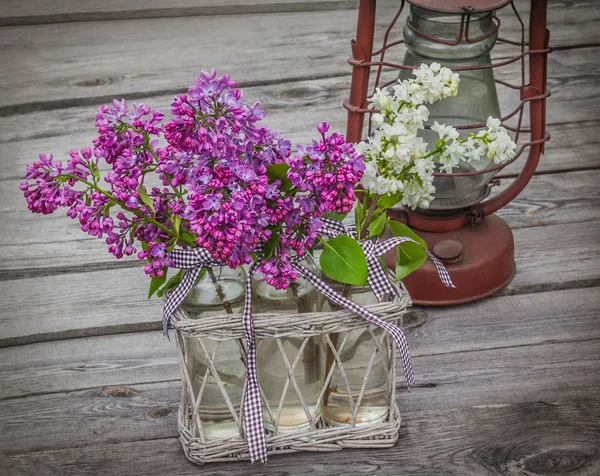 Lilacs and kerosene lamp — Stock Photo, Image