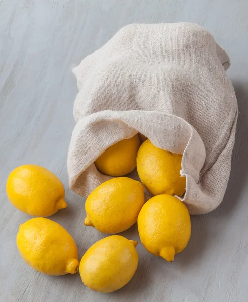 Sack with lemons on table — Stock Photo, Image
