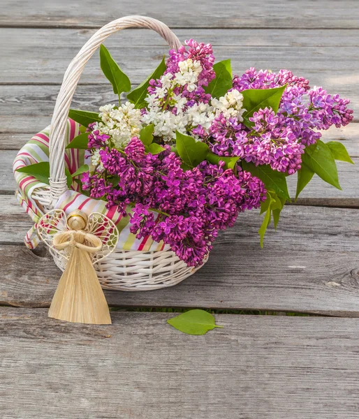 Bouquet of lilac and straw angel — Stock Photo, Image
