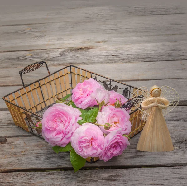 Bouquet of wild roses and angel — Stock Photo, Image