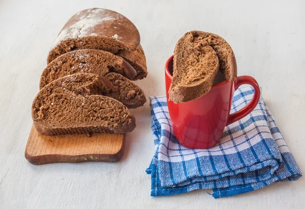 Sliced rye bread and cup with milk — Stock Photo, Image