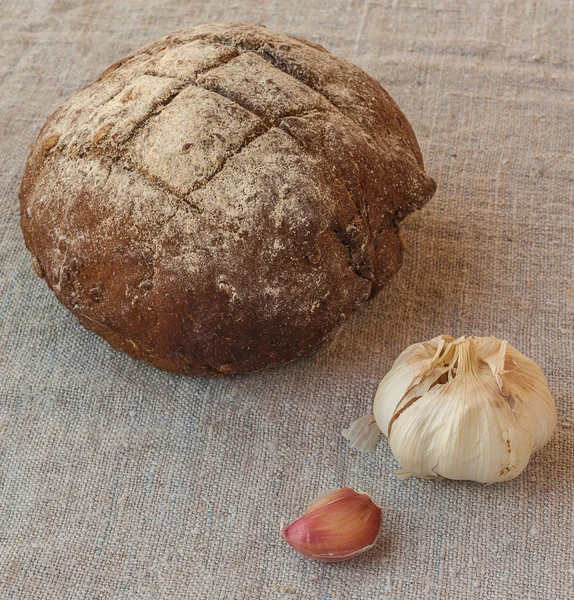 Round rye rusticbread and garlic — Stock Photo, Image