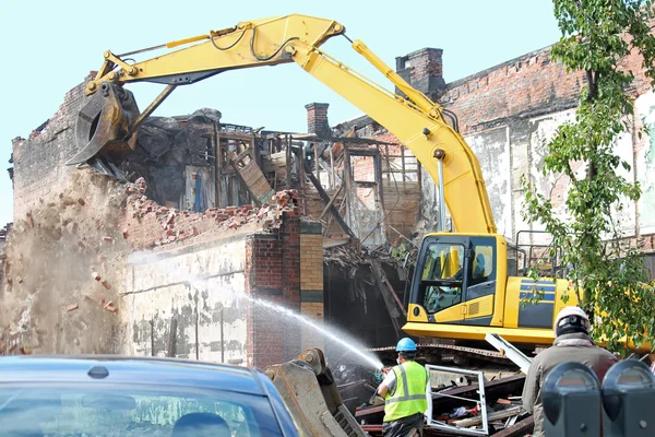 Excavator demolishing building Stock Image