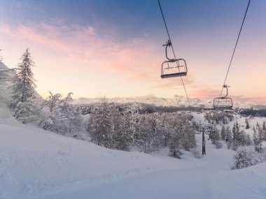 Winter mountains panorama with ski slopes and ski lifts clipart
