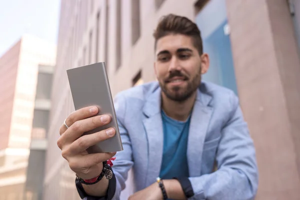 Handsome Young Man Smiling Using His Mobile Phone — Stock Photo, Image