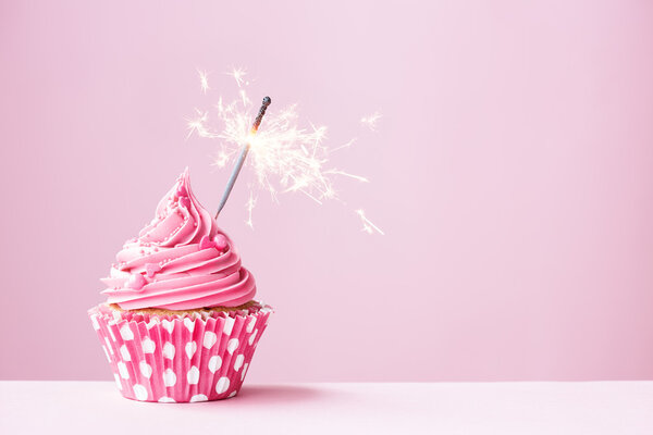 Pink cupcake with sparkler — Stock Photo, Image