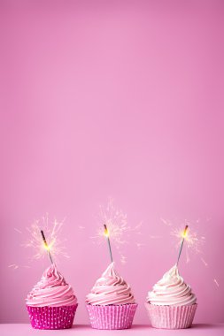 Pink cupcakes with sparklers clipart
