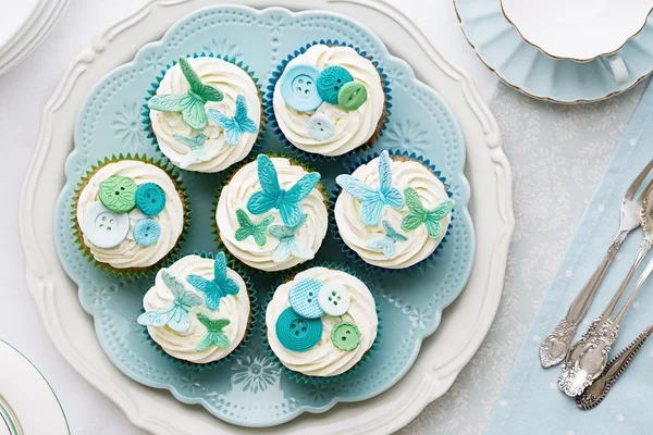 Butterfly and button cupcakes — Stock Photo, Image